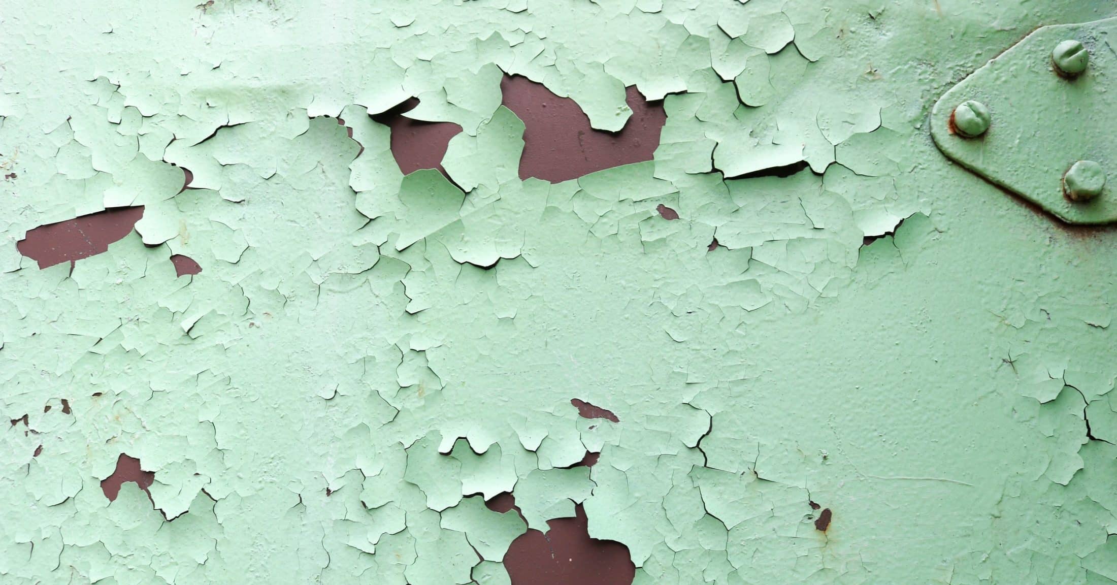 Old paint peeling off a metal surface
